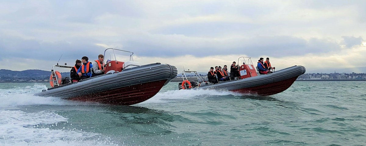 Image of two dinghy's with passengers on the sea