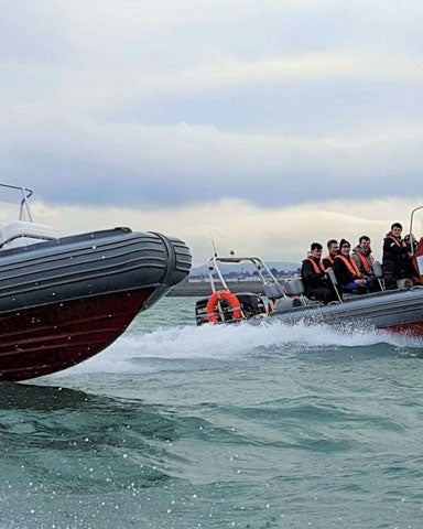 Image of two dinghy's with passengers on the sea