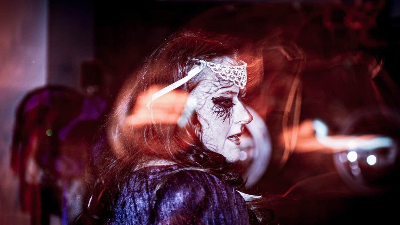 Tour guide with face decorated and dressed as a Celtic goddess