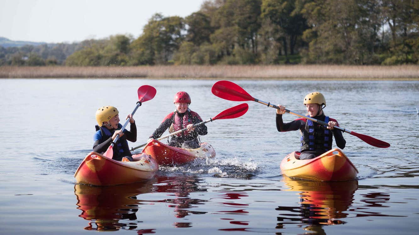 Three people in kayaks on the water