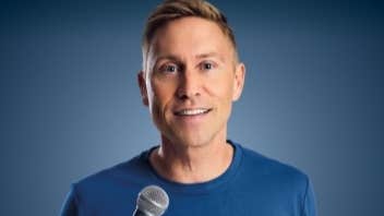 A talking man holding a mic.