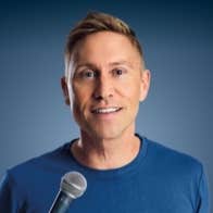 A talking man holding a mic.