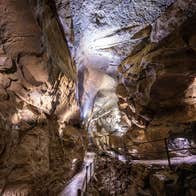 The interior of the limestone cave showing the metal railed walkway that visitors can walk along