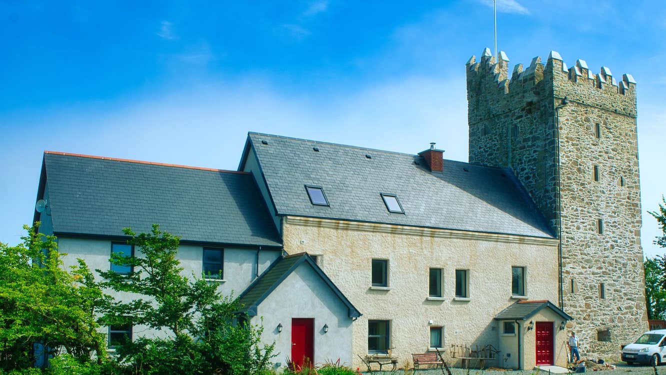An old tower house attached to a two storey home