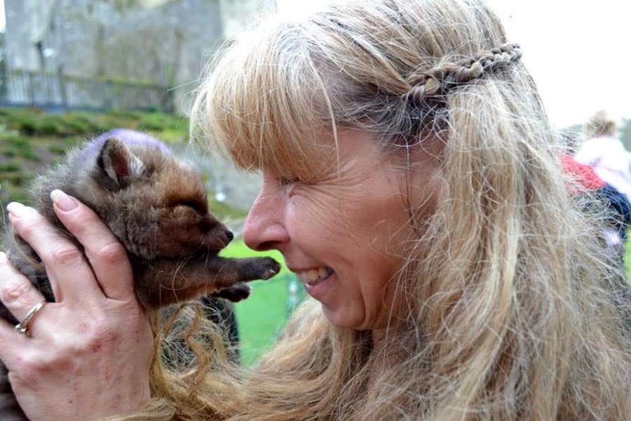 A woman holding a small cub at Animal Magic Wildlife Displays in County LImerick