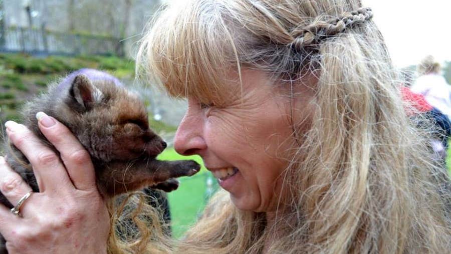 A woman holding a small cub at Animal Magic Wildlife Displays in County LImerick