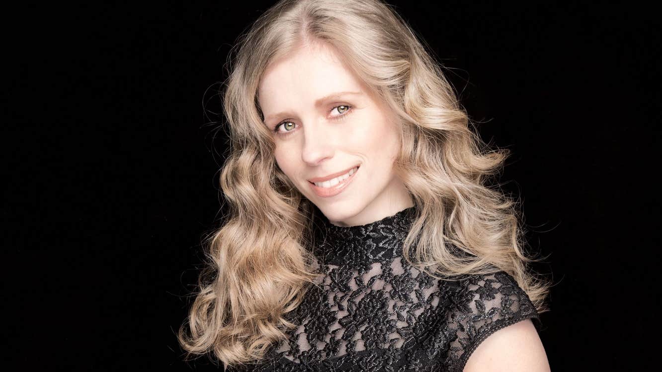 Fionnuala Moynihan is smiling in front of a black background.