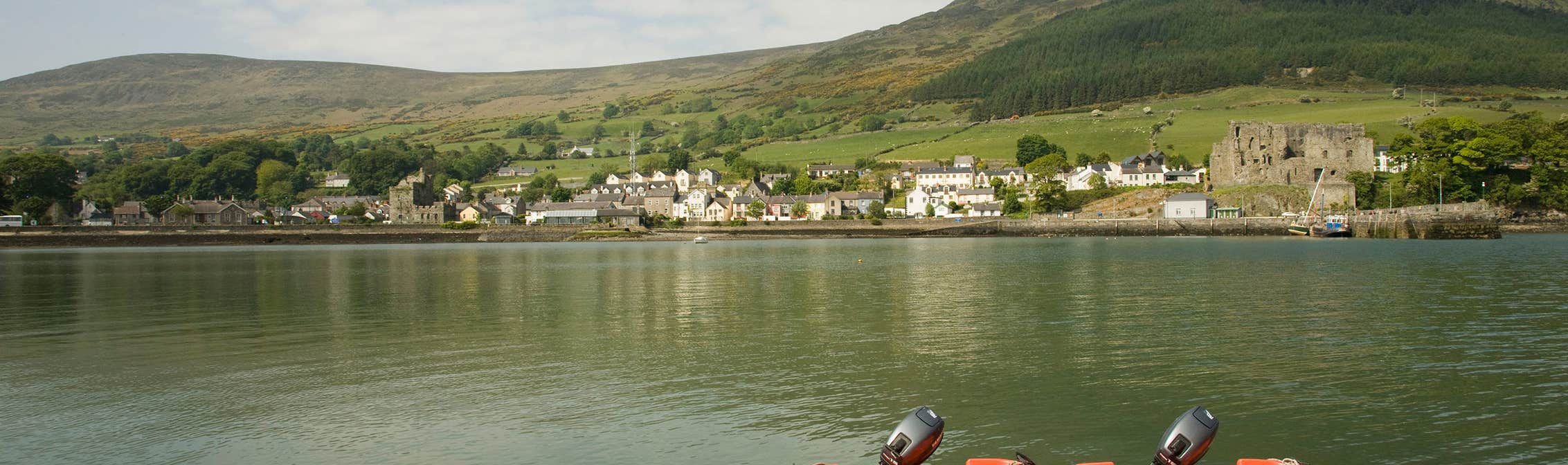 Two orange boats on the water on Carlingford Lough in Louth