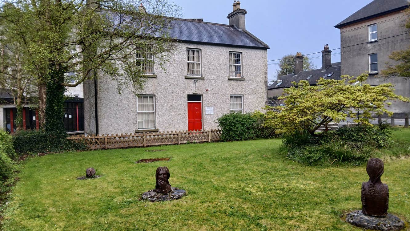 A two storey period building overlooking a small garden