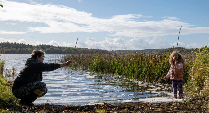 A woman and child by the water in Newtowngore in County Leitrim