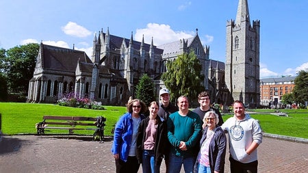 A tour group posed with Christchurch Cathedral in the background
