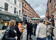 A tour group and guide on a busy city street