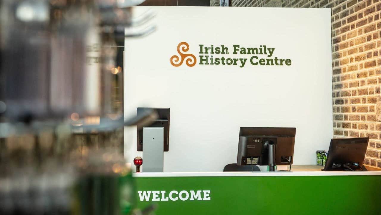 Irish Family History Centre reception desk with three computer monitors