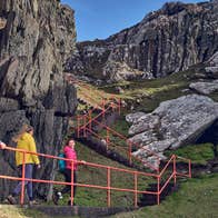 Three people hiking the Sheep's Head Way walking route in County Cork.