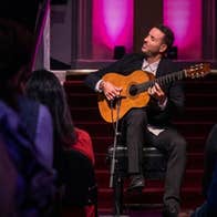 Juan José Manzano, Flamenco Guitar - a seated man playing a guitar with his eyes closed.