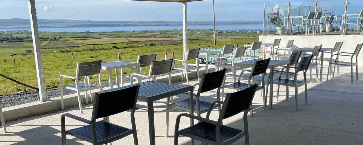 The terrace at Moher Cottage with views of the ocean in the horizon