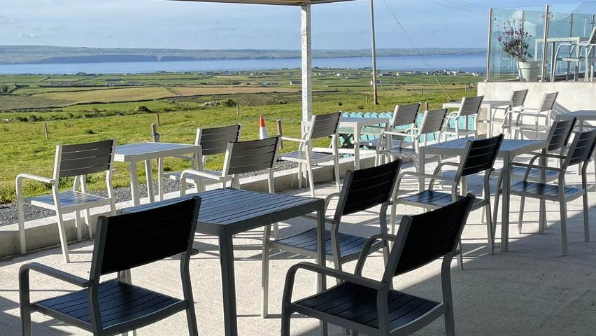 The terrace at Moher Cottage with views of the ocean in the horizon