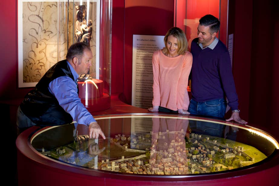 A tour guide leading two people through the exhibits at Waterford Treasures in County Waterford.