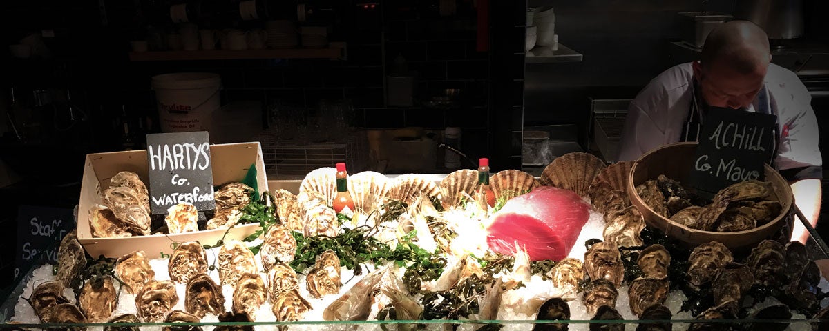 A seafood counter with an array of shellfish on display