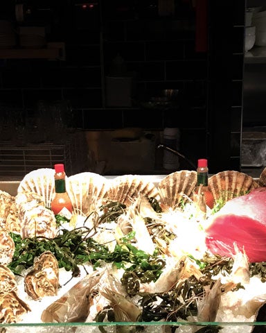 A seafood counter with an array of shellfish on display