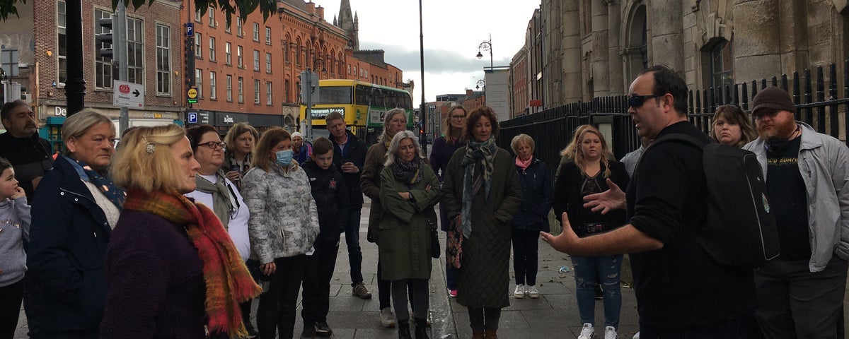 A group of people with a Walking Food Tour guide on a street in Dublin City