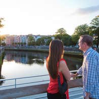 A couple looking out over the river in Cork City.