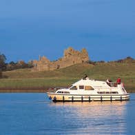 A group of people on a boat cruising the River Shannon near Clonmacnoise, Co.Offaly