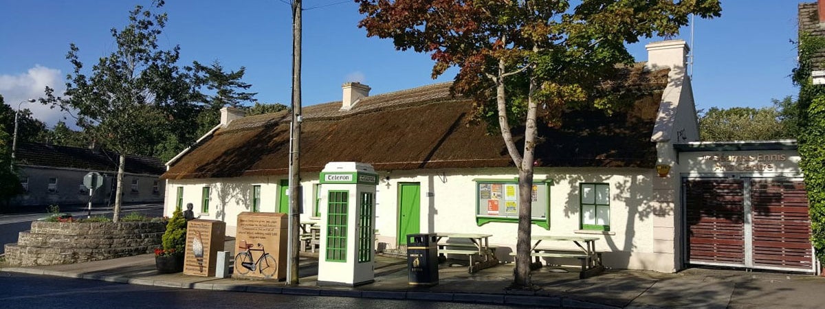 A white washed traditional cottage with a thatched roof