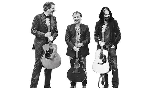 Tom Dunne, Fiachna Ó Braonáin & Alan Connor - black and white photo of 3 men standing, all holding guitars by the neck in front of them against plain white background.
