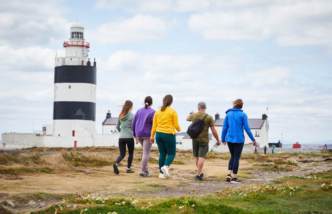 Five people walking up to Hook Lighthouse in County Wexford.