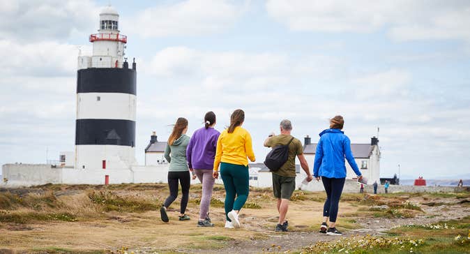 Five people walking up to Hook Lighthouse in County Wexford.