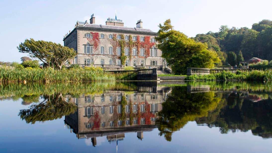 Image of Westport House reflected in a lake in Westport, Co Mayo