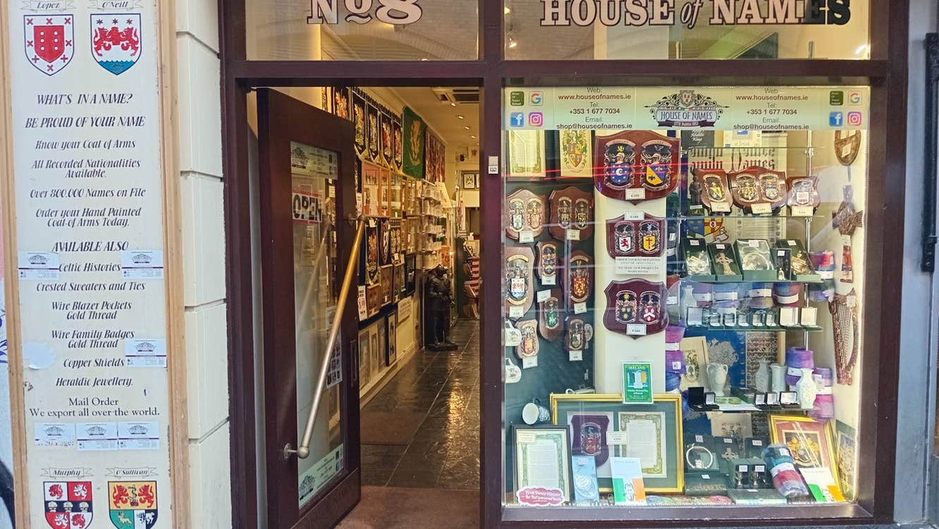 Exterior of a shop with lots of heraldic items on display at the window