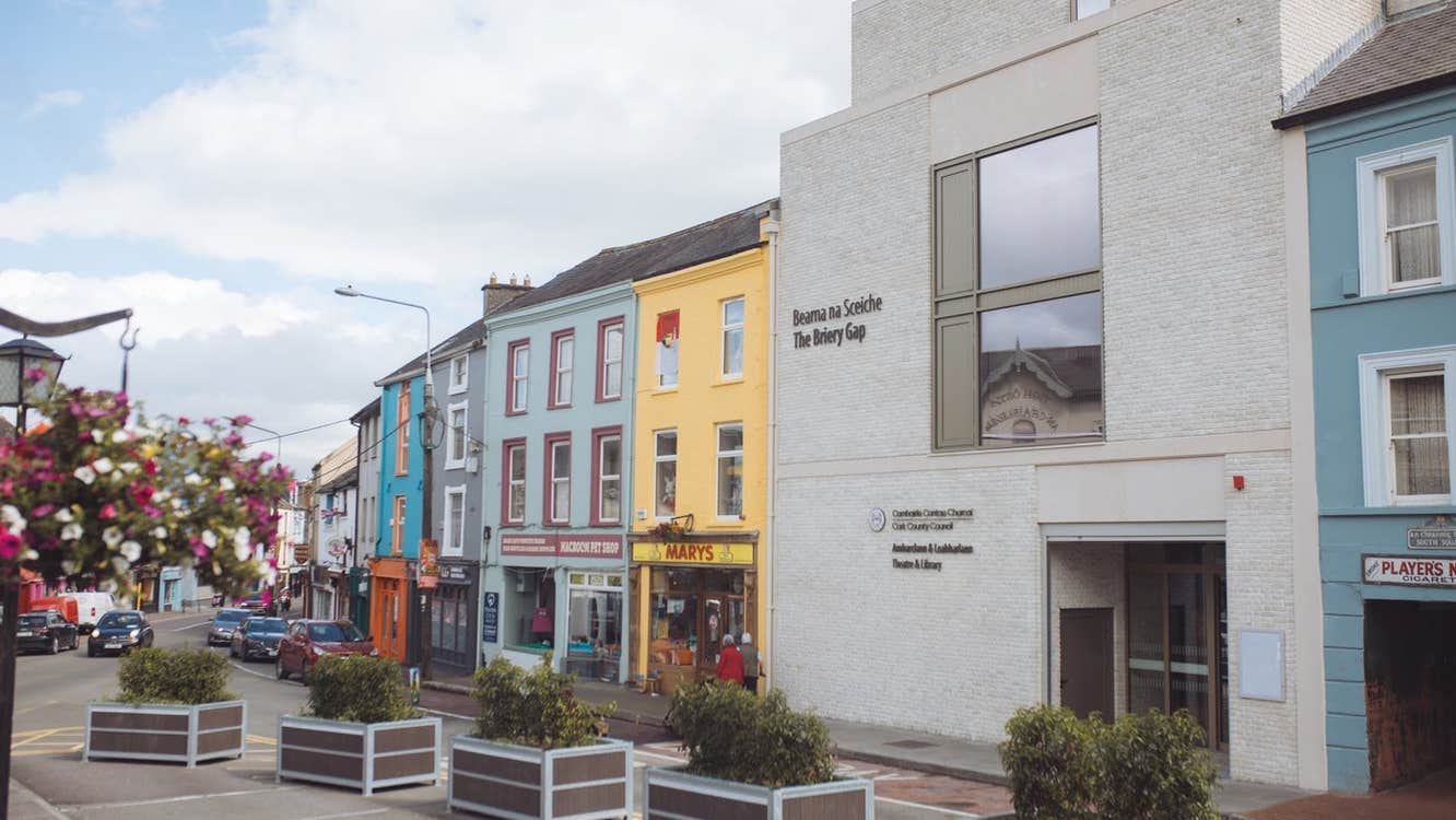 Exterior of a two storey building on a street with planters and shrubs outside