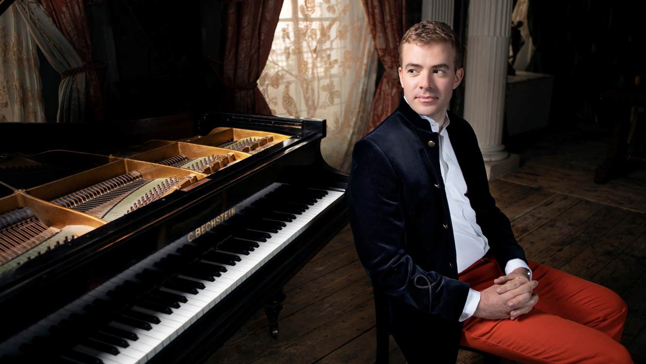 Fiachra Garvey next to a piano.