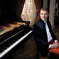 Fiachra Garvey next to a piano.