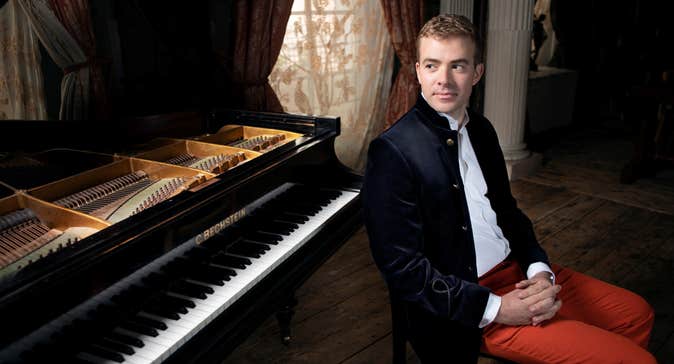 Fiachra Garvey next to a piano.