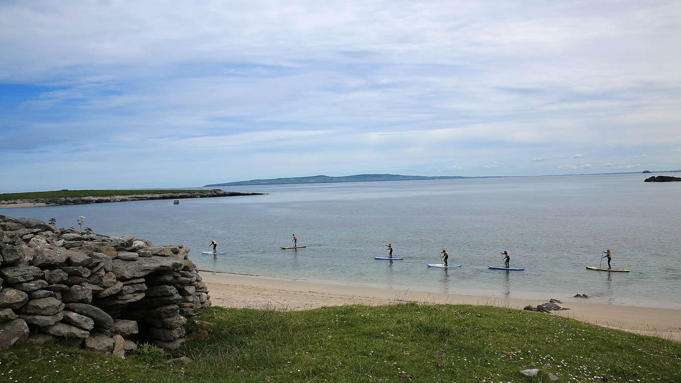 Six people paddle boarding at Castlegregory Beach in County Kerry.
