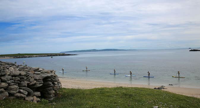 Six people paddle boarding at Castlegregory Beach in County Kerry.
