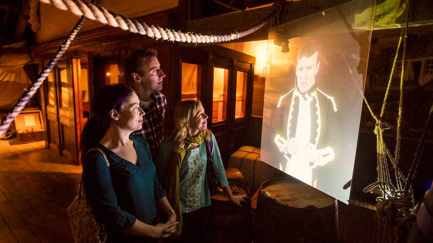 Three people looking at the exhibitions on display at Wicklow Gaol