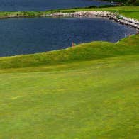 A view of Cork Golf Club Green with a view of an inlet