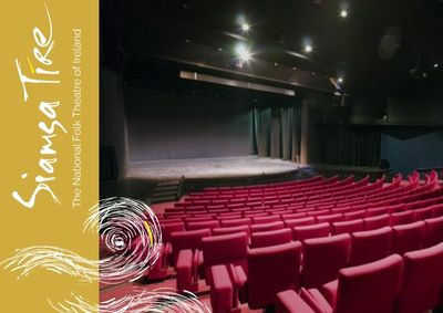 May-Sept: VIP Experience ‘Celebrate’ Package at Siamsa Tíre Theatre, Tralee, inside of the theatre looking at the stage with rows of empty red seats.