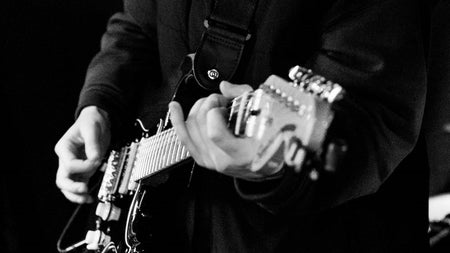 Gentleman playing an electric guitar