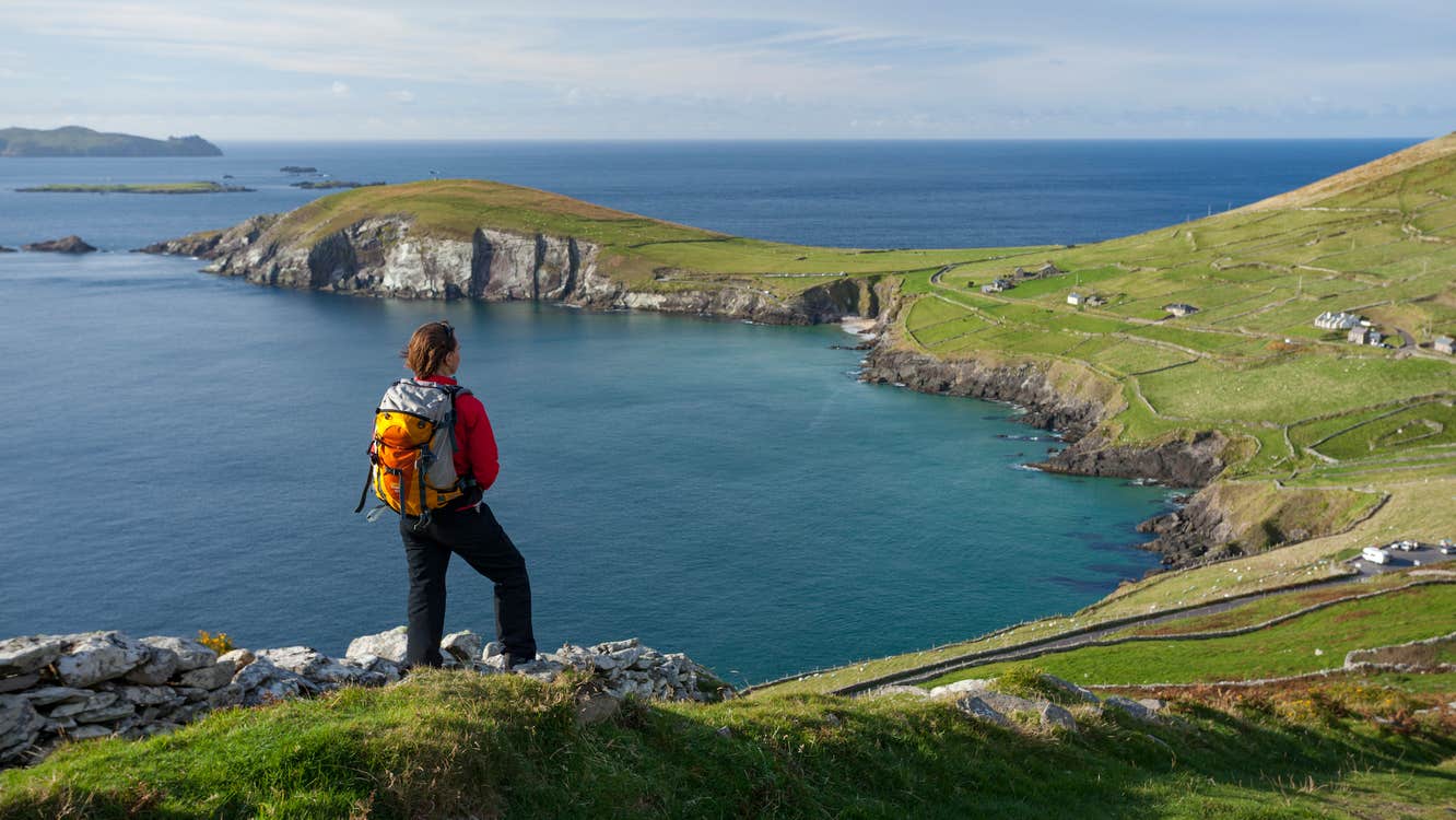 A hiker looking out over Slea Head in Dingle, County Kerry