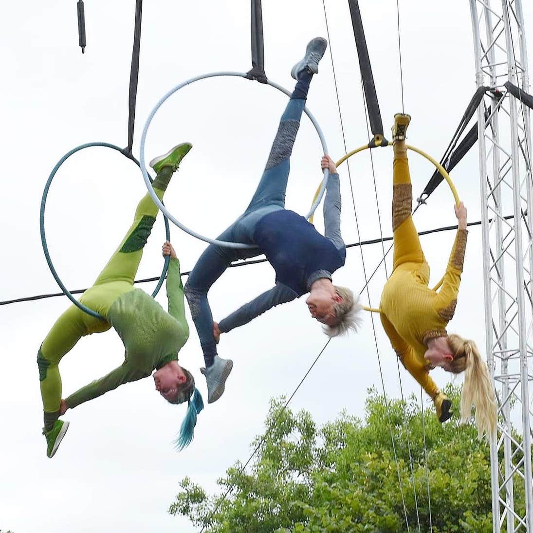 Three aerial performers dangling in rings at the Spraoi International Street Arts Festival in Waterford.