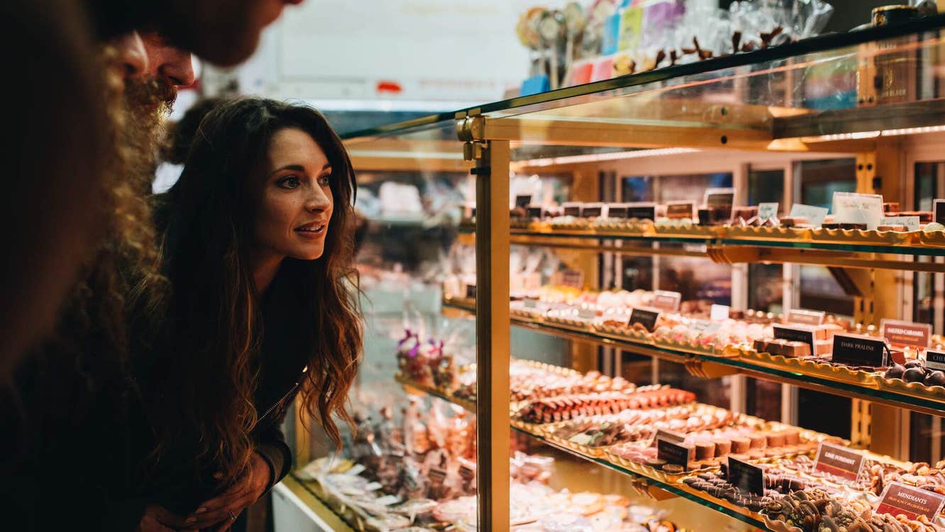 Woman looking at display of baked goods