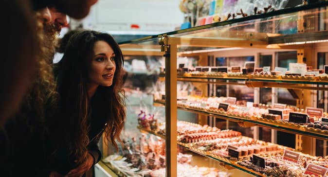 Woman looking at display of baked goods