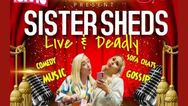 2 women posing for selfies with images of a stage with red curtains and old style large mics.