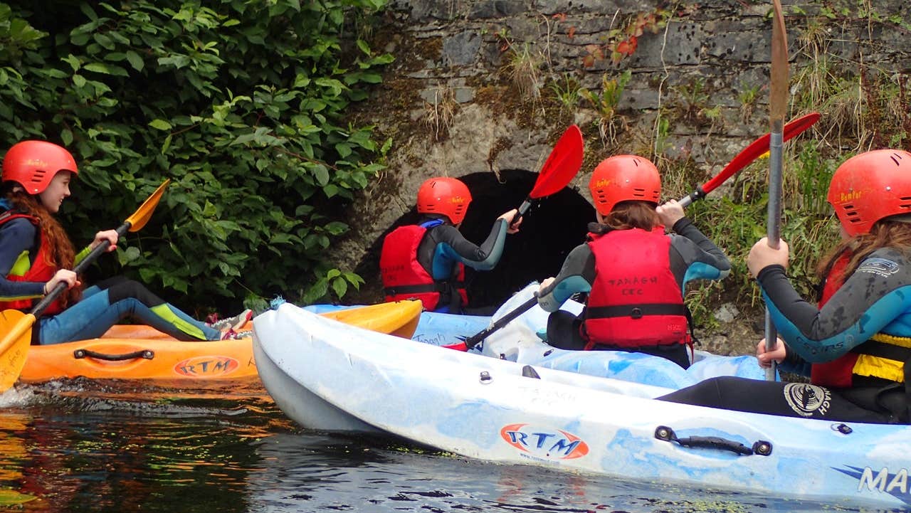 A group of children kayaking with Tanagh Outdoor Education & Training Centre