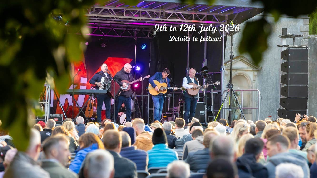 Comeraghs Wild Festival 2026 - a stage outdoors with musicians playing and audience watching on